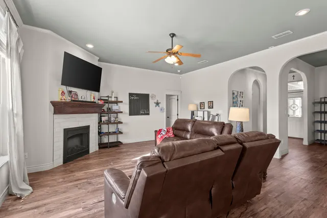 a living room with furniture a fireplace and a flat screen tv