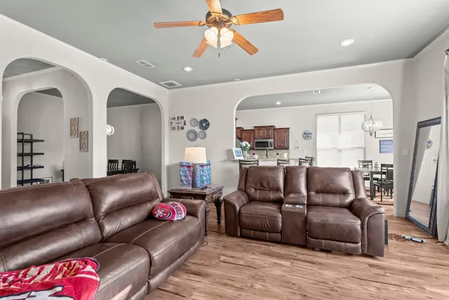 a living room with furniture and a wooden floor