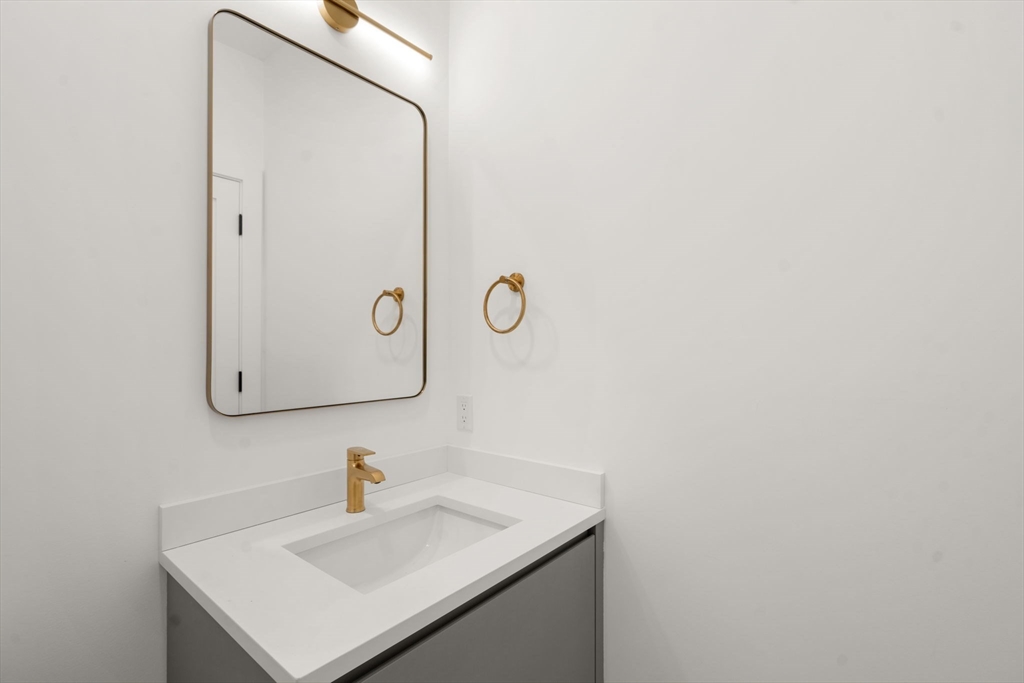 16 Stearns Road, Unit 108 Wellesley, MA 02482 - Photo 23 of 29 a bathroom with a sink and a mirror