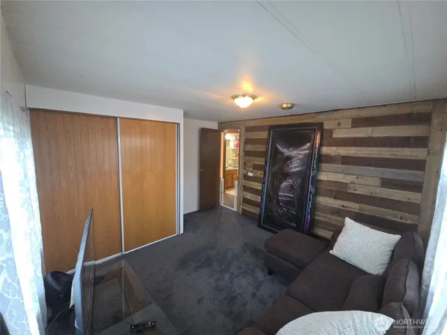 a living room with furniture and a closet