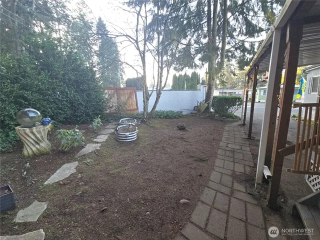 a view of a backyard with iron fence