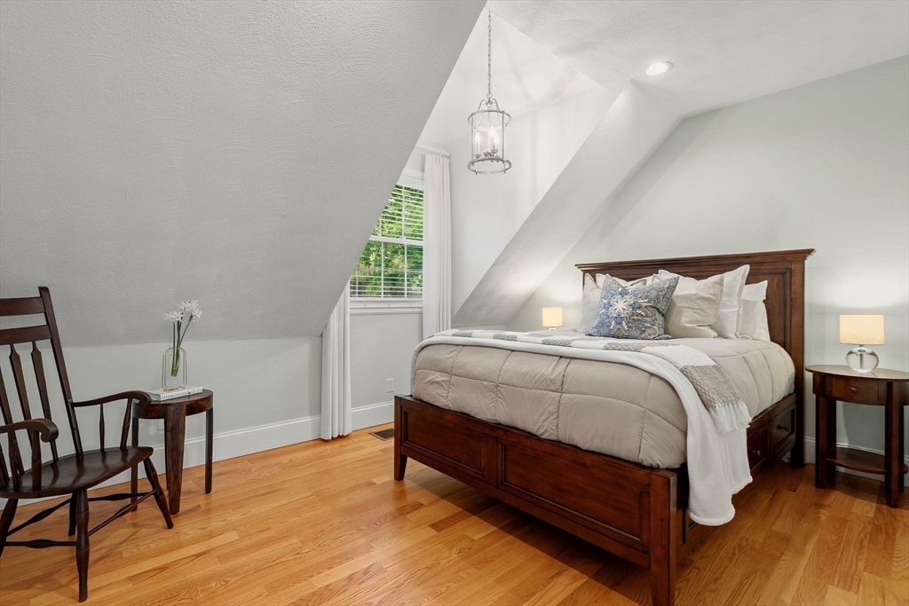 165 Park Avenue, Unit 165 Arlington, MA 02476 - Photo 15 of 32 a bedroom with a bed a table and chair