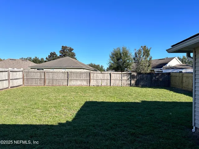 a view of a backyard with a garden and plants