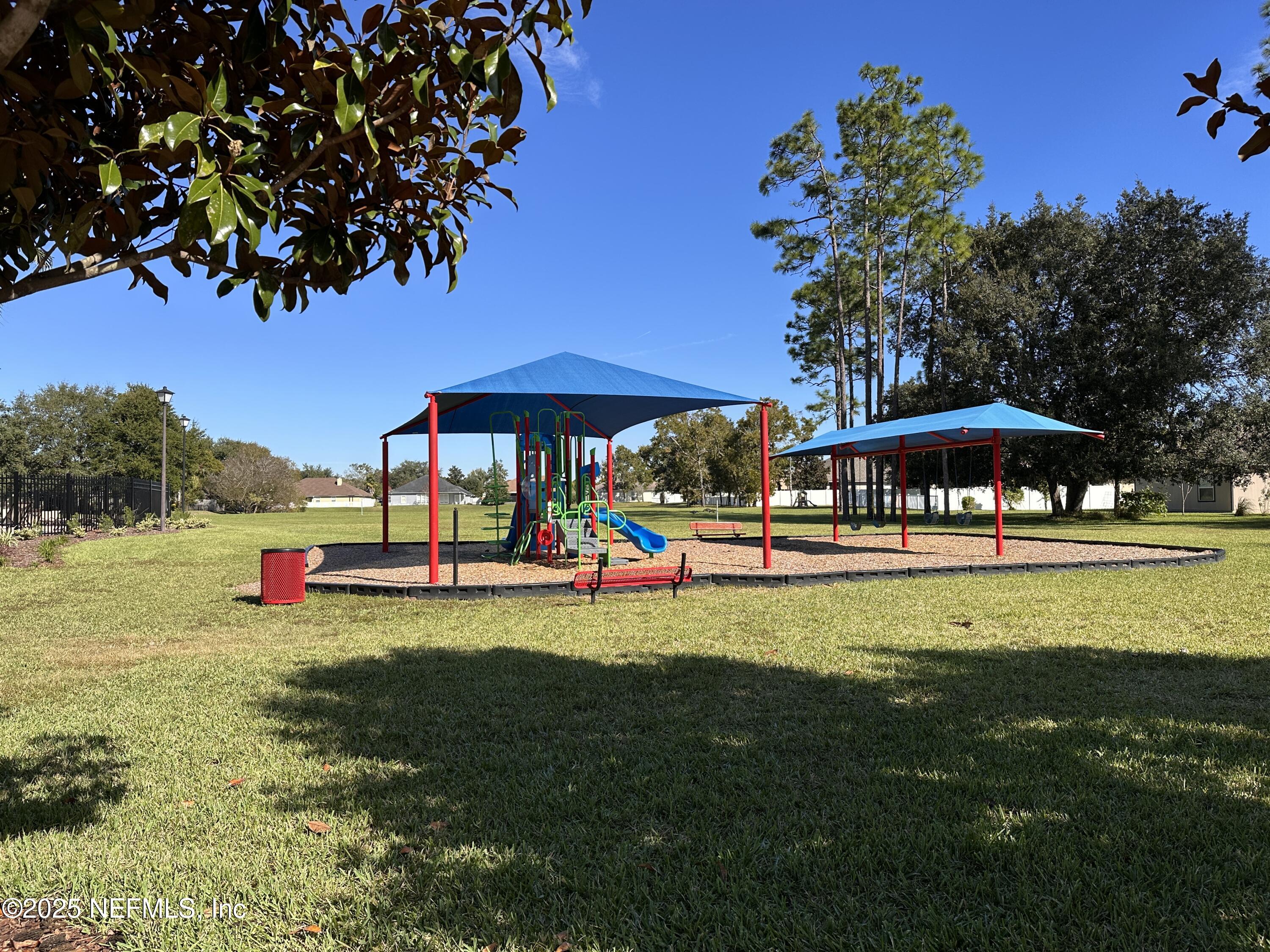 2786 Cross Creek Drive Green Cove Springs, FL 32043 - Photo 15 of 16 a view of a swimming pool with lawn chairs under an umbrella