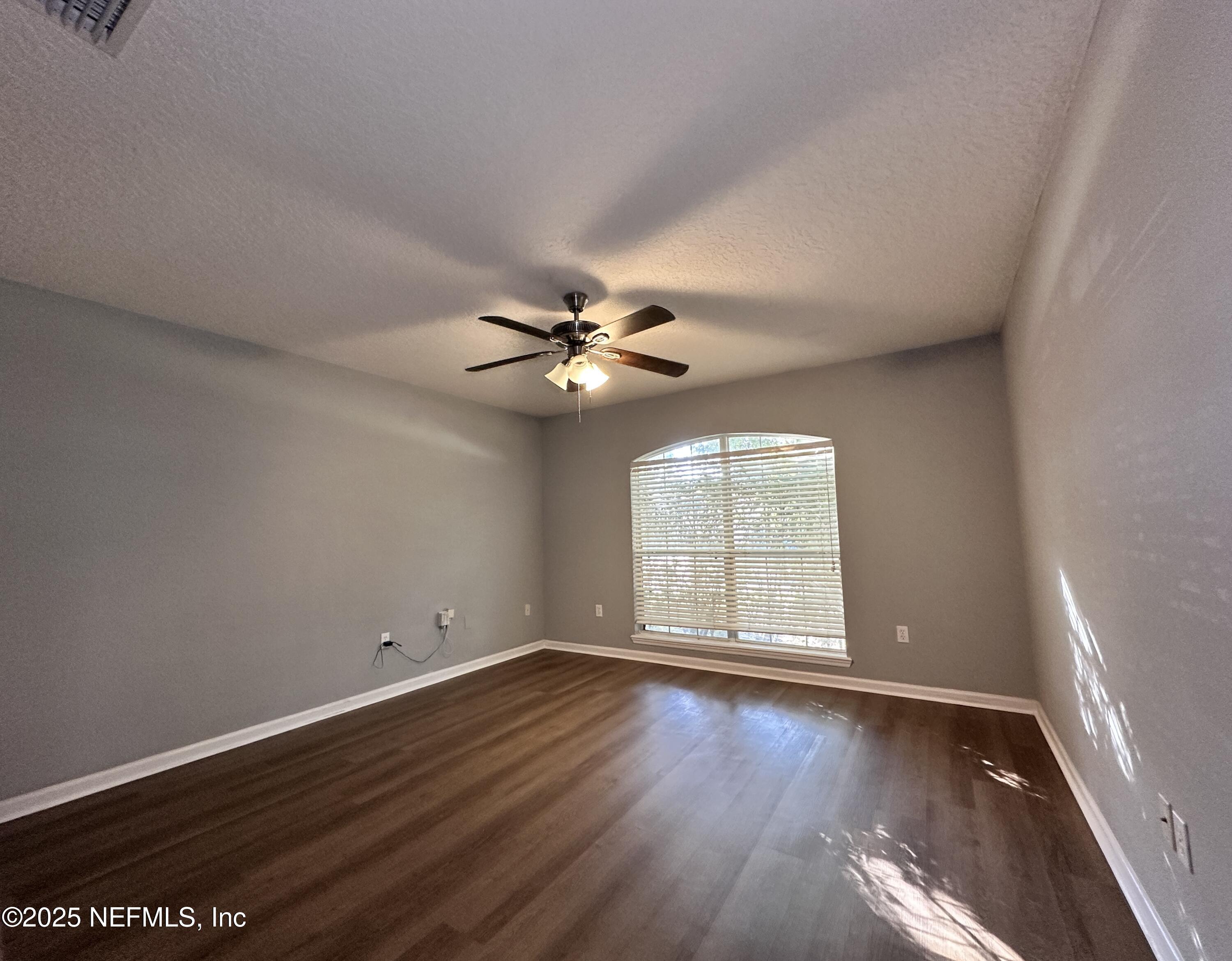 2786 Cross Creek Drive Green Cove Springs, FL 32043 - Photo 7 of 16 wooden floor in an empty room with a window