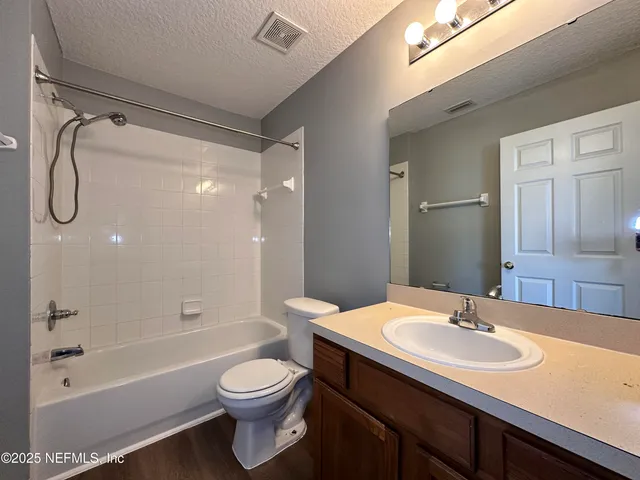 a bathroom with a sink a toilet and a bathtub