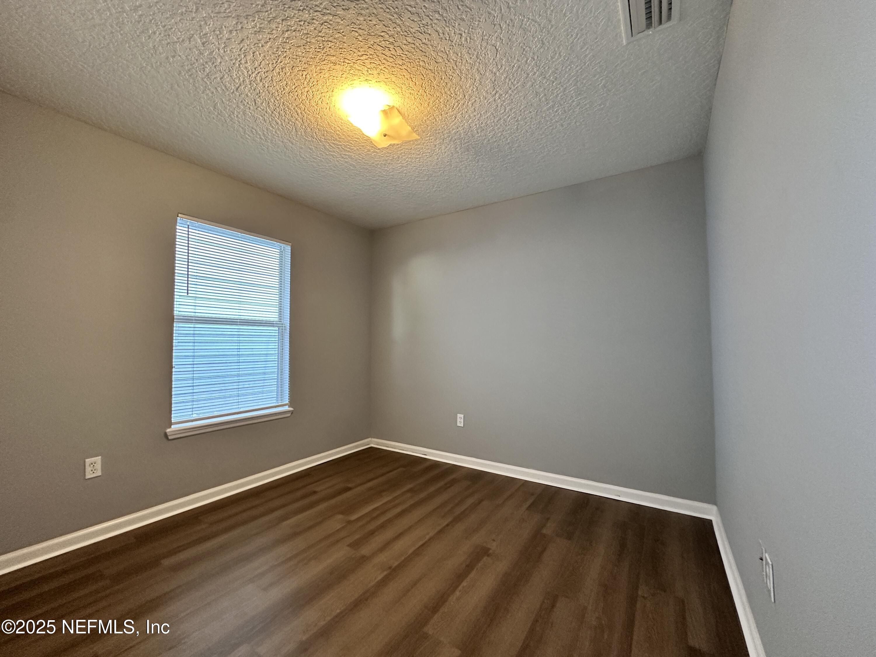 2786 Cross Creek Drive Green Cove Springs, FL 32043 - Photo 10 of 16 a view of an empty room with wooden floor and a window