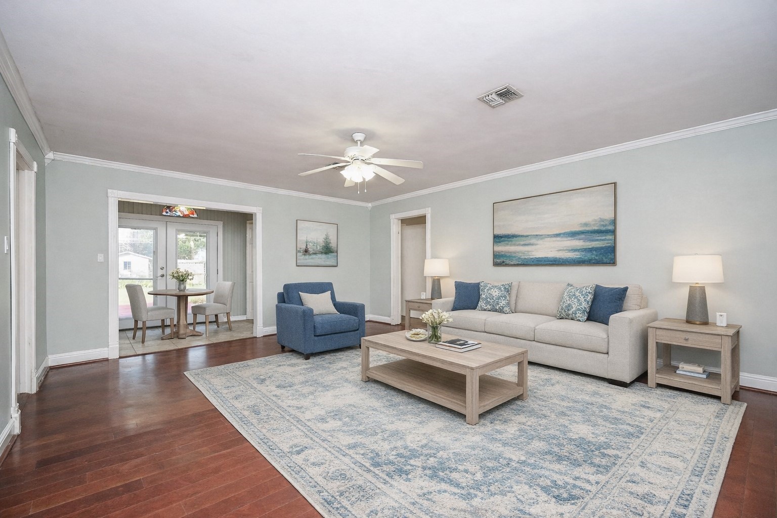 1707 Key Street Waller, TX 77484 - Photo 6 of 26 Very spacious family room- crown molding, ceiling fan and open to to breakfast area and formal dining room. Beautiful wood flooring and recently painted. *virtually staged*