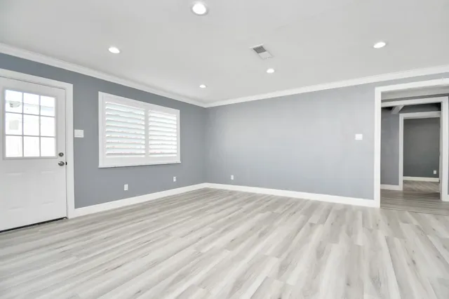 wooden floor in an empty room with a window