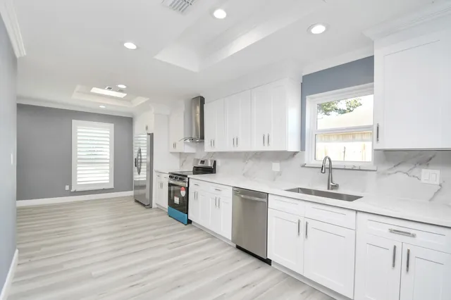 a kitchen with a sink wooden floor and window