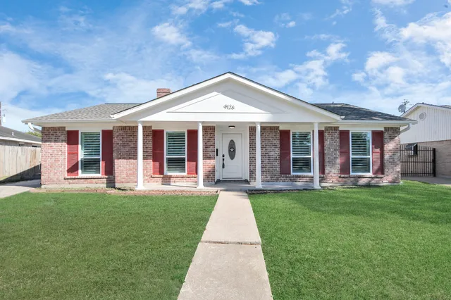 a front view of a house with a yard and porch