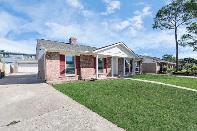 a front view of a house with a garden and porch