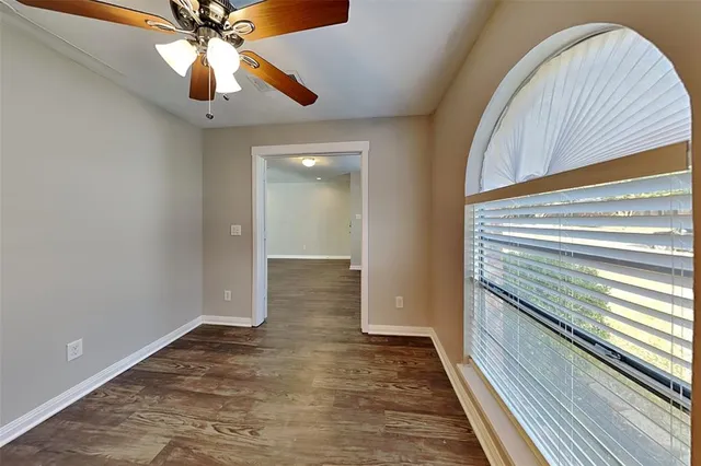 a view of an empty room with a ceiling fan