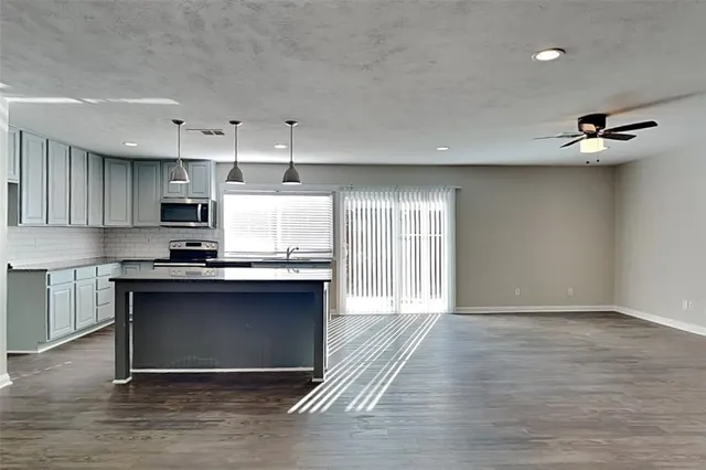 a view of a house with wooden fence