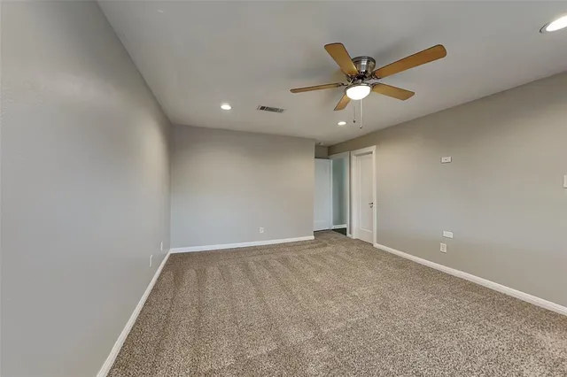 a view of a livingroom with wooden floor and staircase