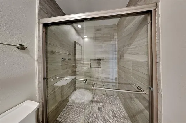 a bathroom with a granite countertop sink a toilet and a mirror