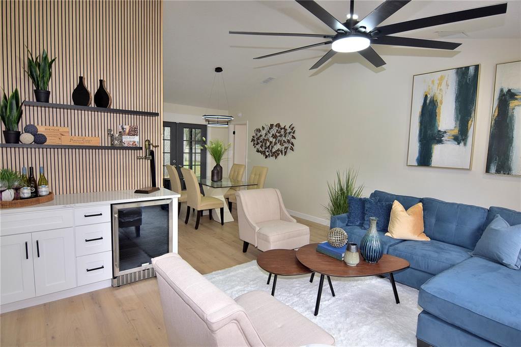 4014 Treetop Circle Spring Hill, FL 34606 - Photo 11 of 31 a living room with furniture a flat screen tv and a window