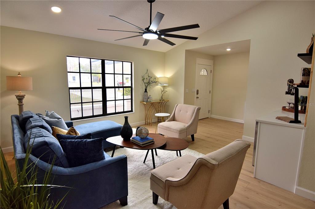 4014 Treetop Circle Spring Hill, FL 34606 - Photo 13 of 31 a living room with furniture a ceiling fan and a window
