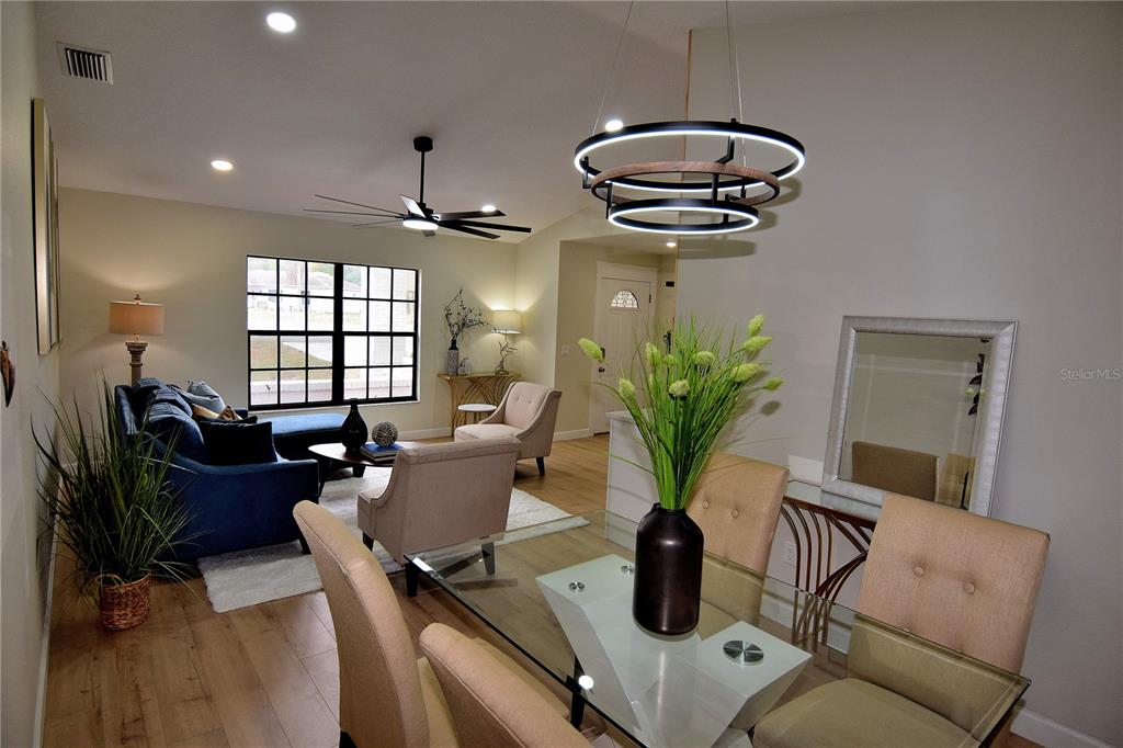 4014 Treetop Circle Spring Hill, FL 34606 - Photo 14 of 31 a living room with furniture a chandelier and a window
