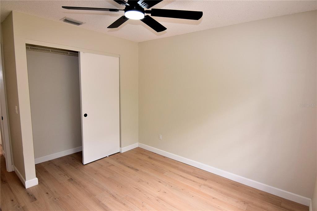 4014 Treetop Circle Spring Hill, FL 34606 - Photo 24 of 31 a view of an empty room with wooden floor