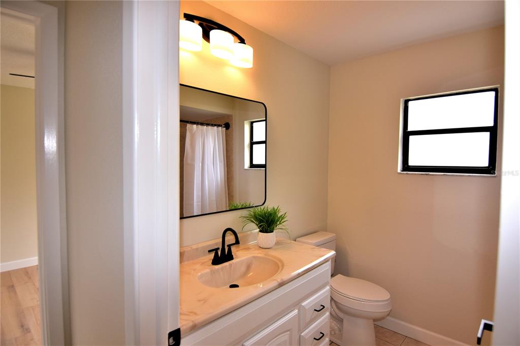 4014 Treetop Circle Spring Hill, FL 34606 - Photo 25 of 31 a bathroom with a sink and a mirror