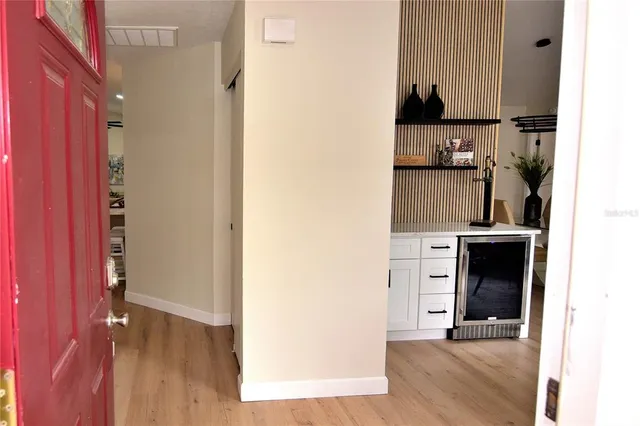 a view of a living room with furniture and wooden floor