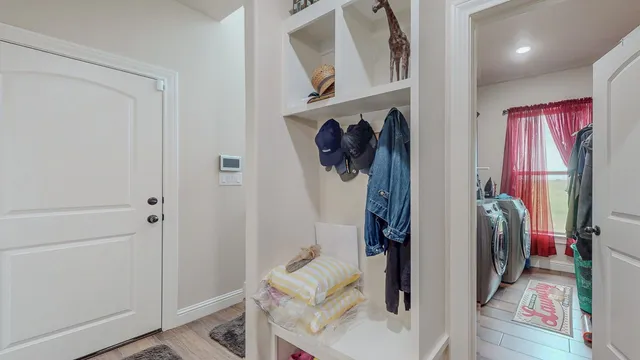 a view of hallway with wooden floor and stairs