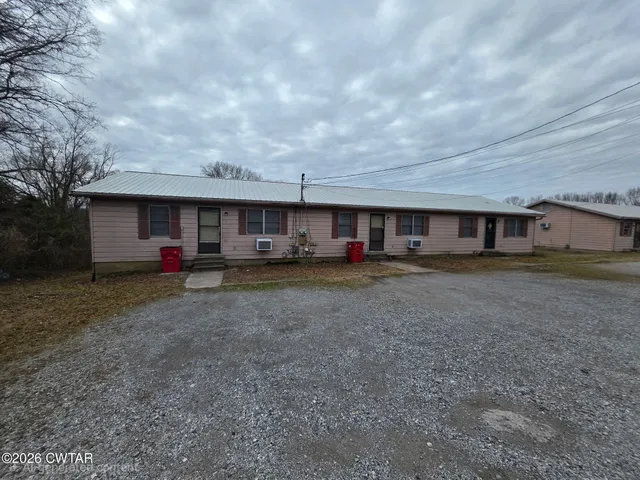 a view of large house with a yard and table