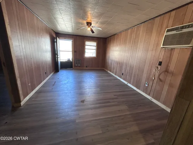 a view of hallway with stairs and wooden floor