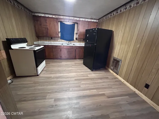 a kitchen with stainless steel appliances granite countertop a refrigerator and a stove