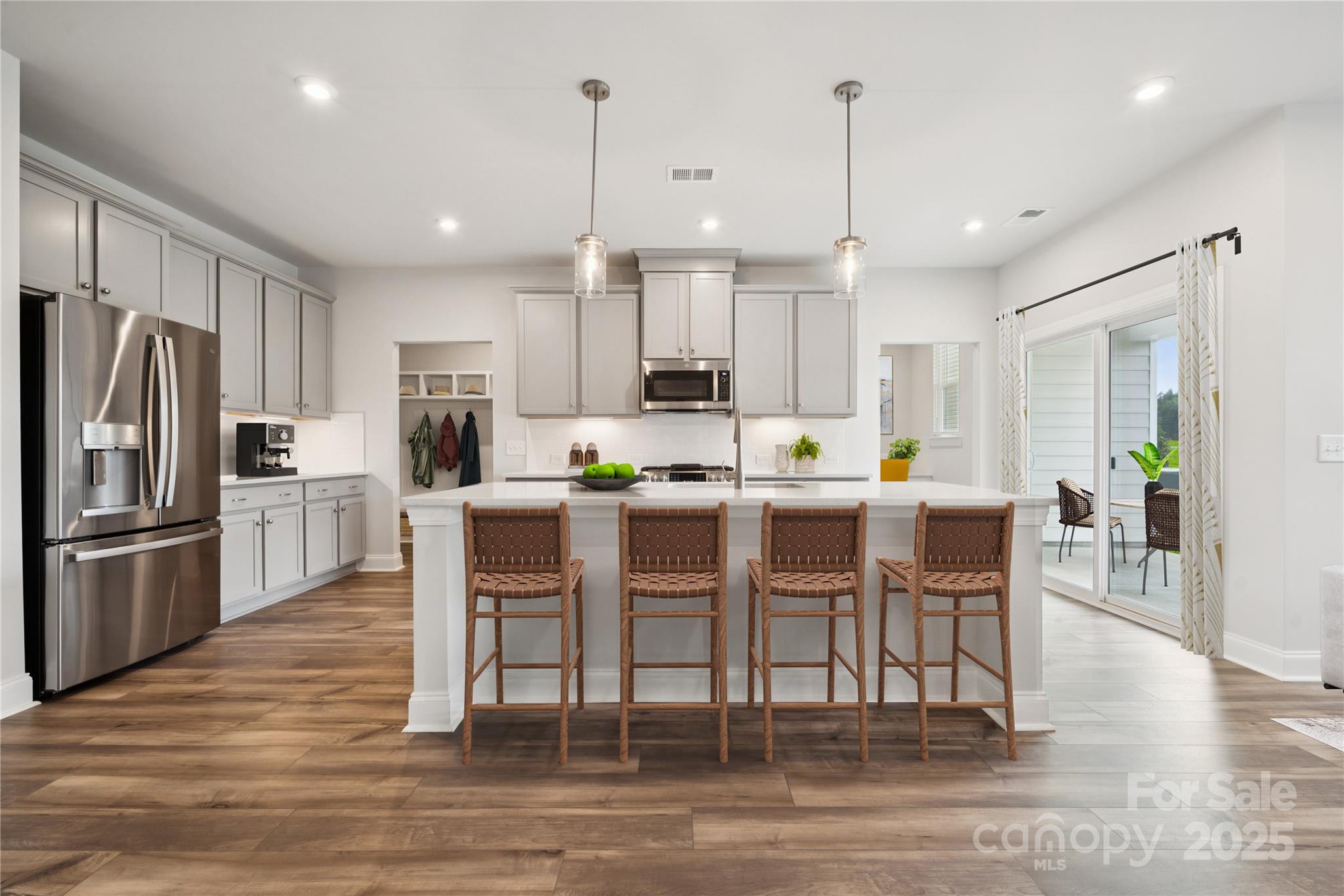 1233 Margo Mannor None Fort Mill Fort Mill, SC 29708 - Photo 12 of 34 a kitchen with stainless steel appliances kitchen island granite countertop a dining table chairs refrigerator and sink
