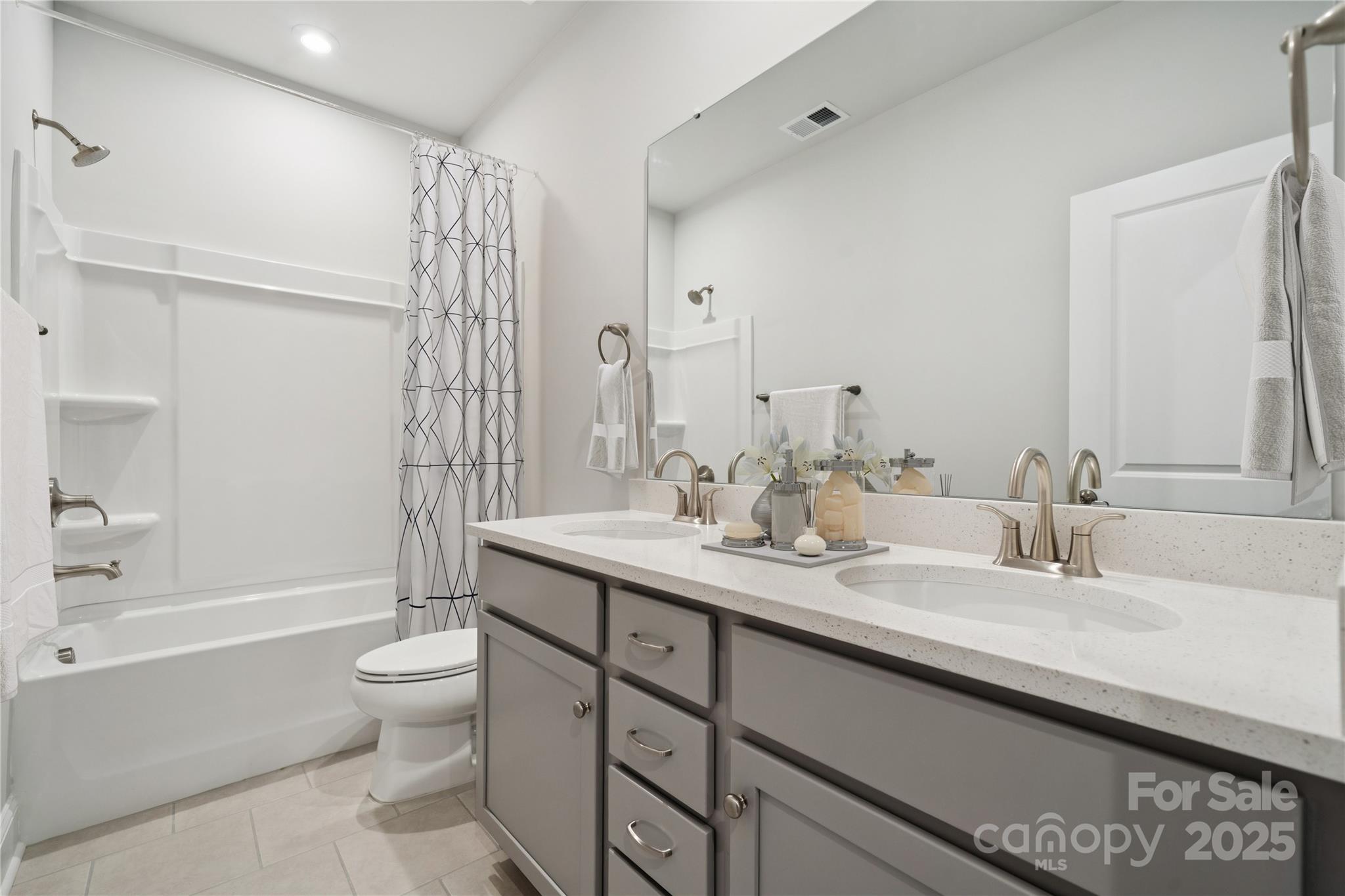 1233 Margo Mannor None Fort Mill Fort Mill, SC 29708 - Photo 15 of 34 a bathroom with a double vanity sink toilet mirror and bathtub