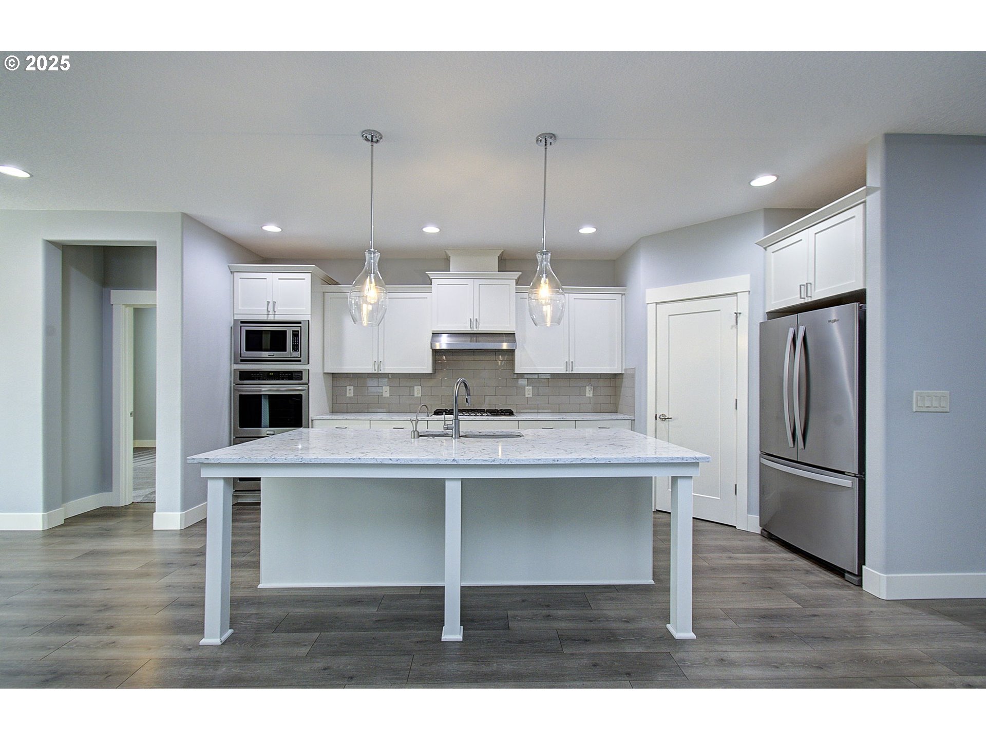 5305 Northeast 134th Street Vancouver, WA 98686 - Photo 12 of 36 a view of kitchen with refrigerator microwave and wooden floor