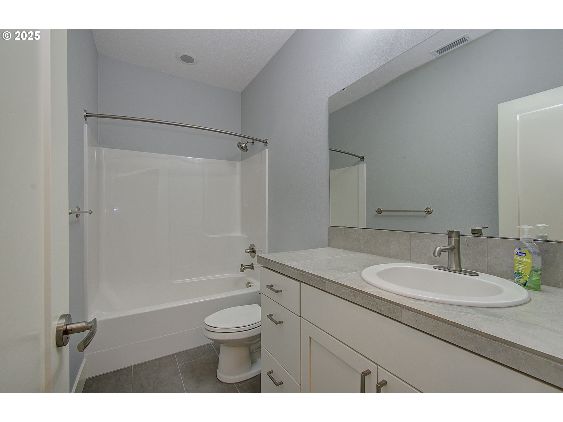 5305 Northeast 134th Street Vancouver, WA 98686 - Photo 20 of 36 a bathroom with a granite countertop sink toilet a mirror and shower