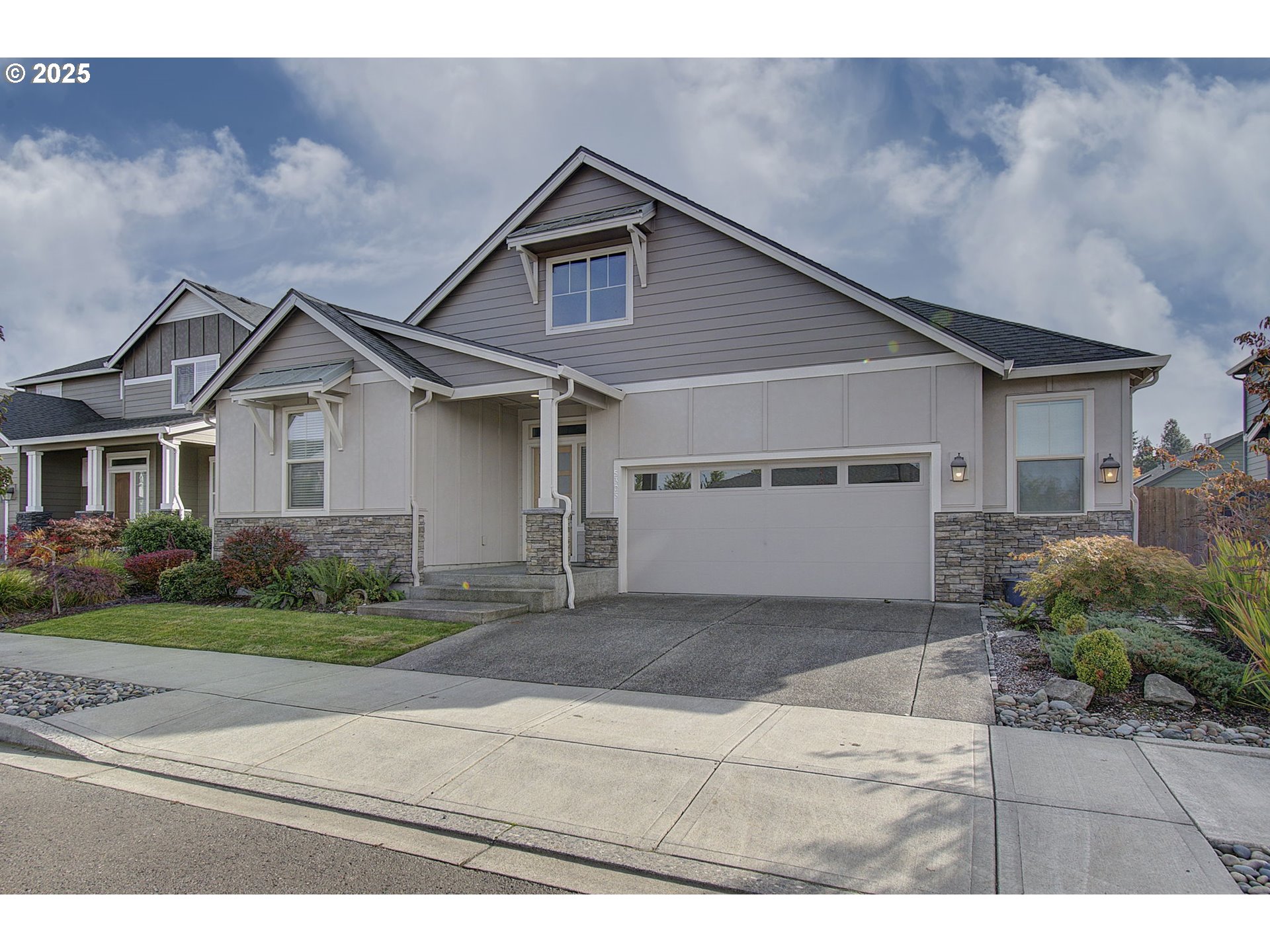 5305 Northeast 134th Street Vancouver, WA 98686 - Photo 3 of 36 a front view of a house with a yard and garage