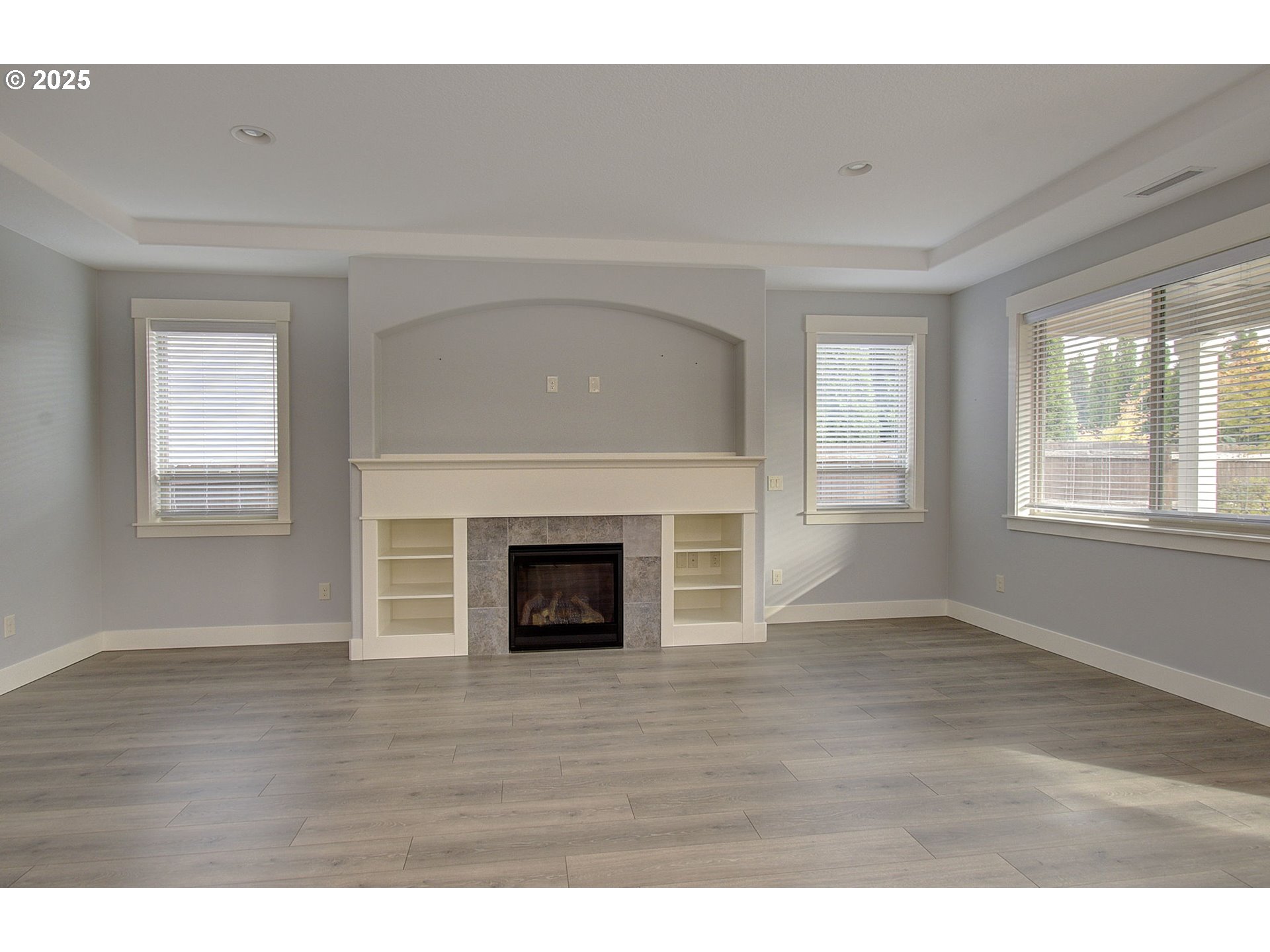 5305 Northeast 134th Street Vancouver, WA 98686 - Photo 8 of 36 a view of an empty room with wooden floor fireplace and a window