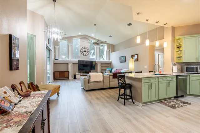 a living room with furniture kitchen view and a fireplace
