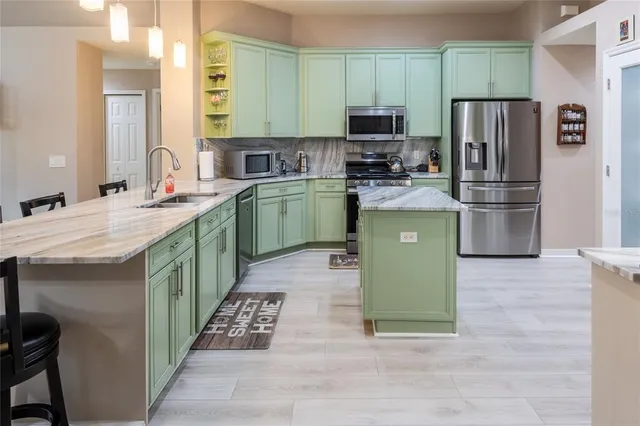 a kitchen with a sink cabinets and stainless steel appliances