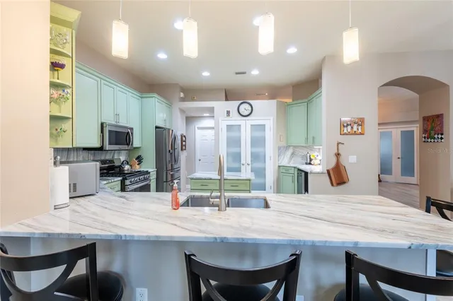a kitchen with center island and stainless steel appliances