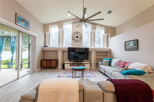 a living room with furniture a large window and a fireplace