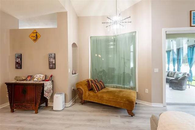 a bedroom with a bed and a chandelier