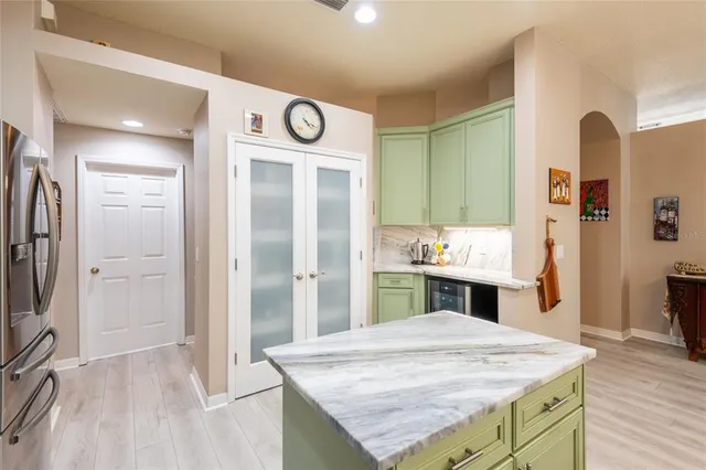 a kitchen with stainless steel appliances kitchen island a refrigerator and a sink