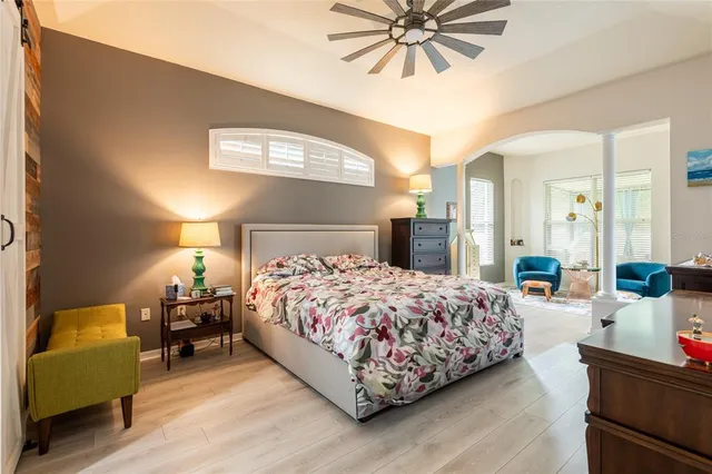 a bedroom with a bed and a chandelier