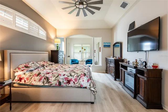 a bedroom with a bed and a flat screen tv