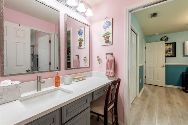 a en suite bathroom with a sink double vanity and a mirror