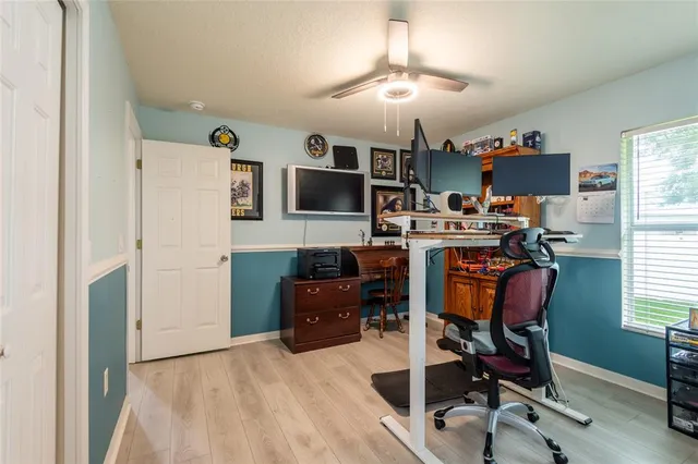 a view of a workspace with furniture and wooden floor