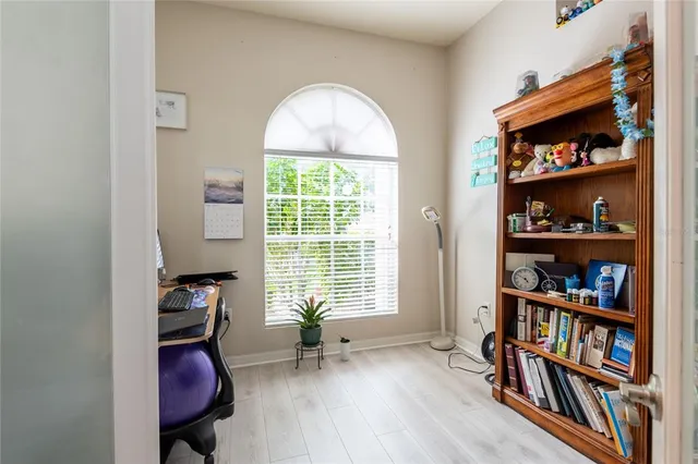 a living room with furniture and floor to ceiling windows