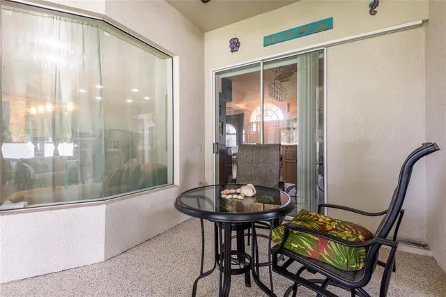 a view of a house with a big yard and palm trees