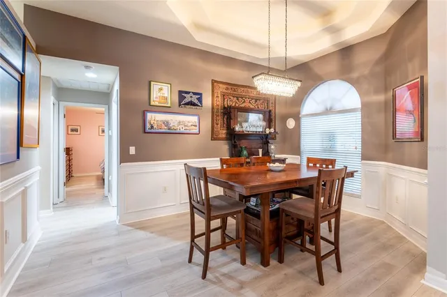 a view of a dining room with furniture and a chandelier
