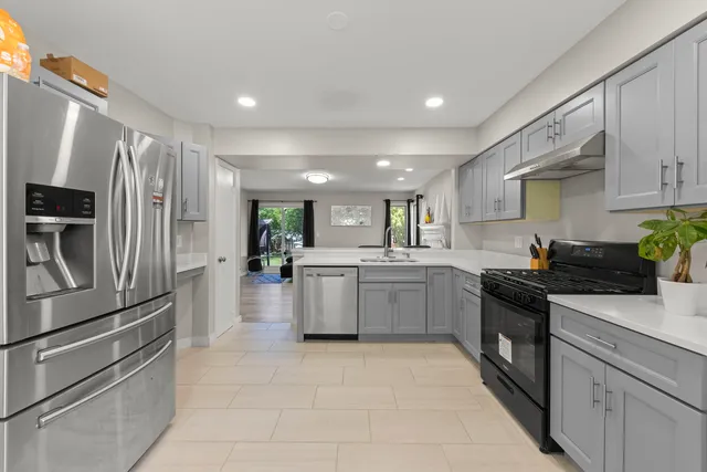 a kitchen with a sink stainless steel appliances and cabinets